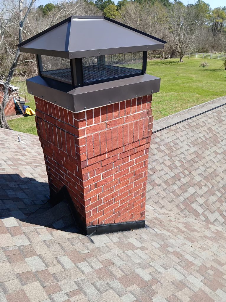A newly installed metal chimney cap on a red brick chimney by Brushers Chimneys in Houston, TX.