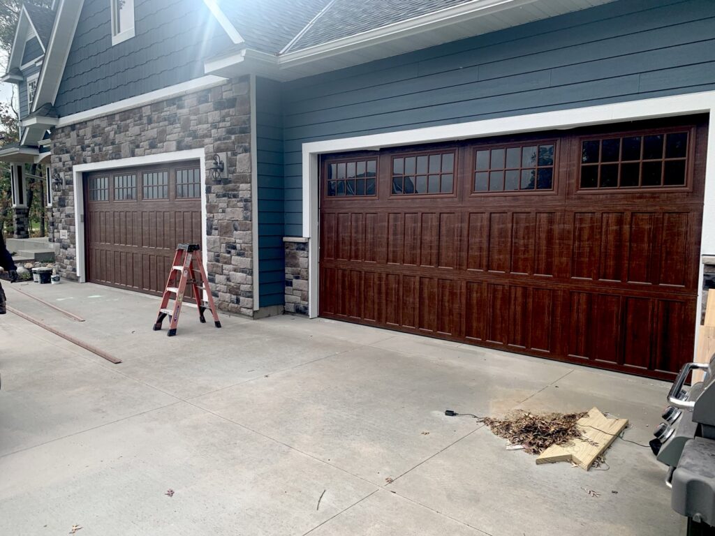 Two newly installed brown garage doors on a modern home by Align Garage Door in Ringgold, GA.