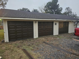 Three new brown garage doors recently installed by The Garage Man in Memphis, TN.