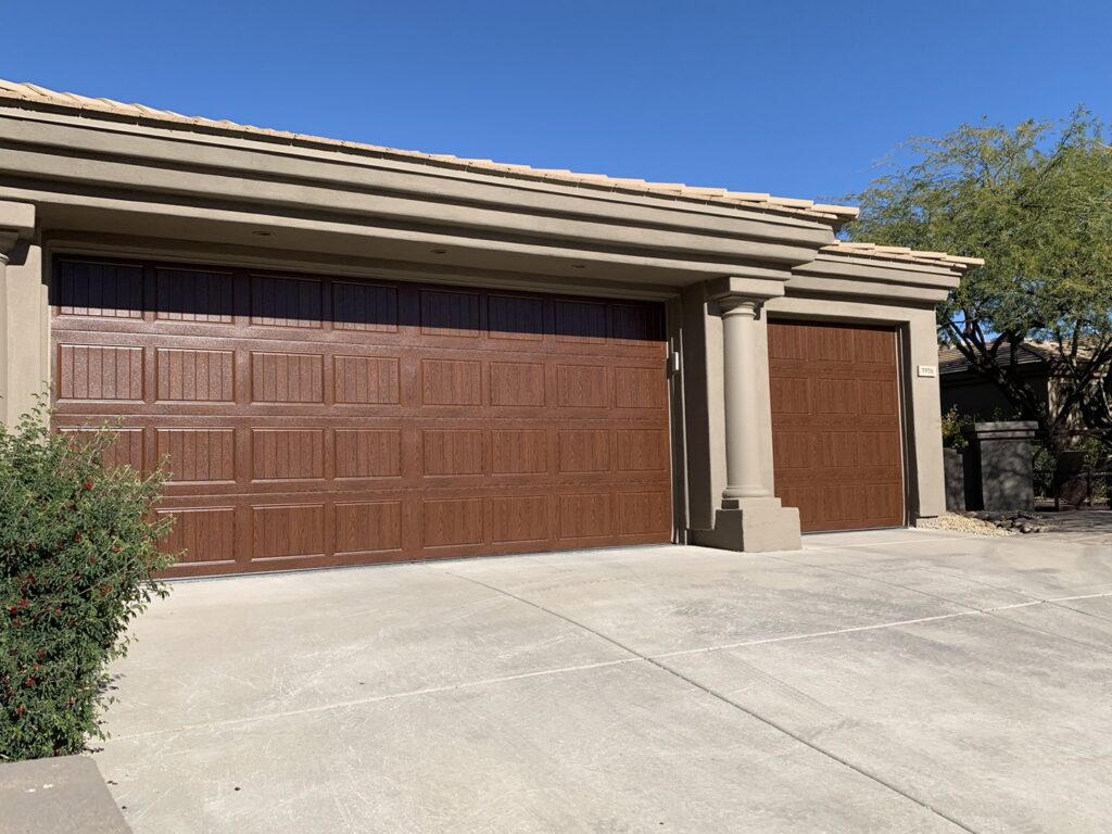 A residential home with two new brown garage doors, a project by Fix It Now Garage Doors.com in Tempe, AZ.