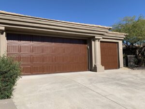 A residential home with two new brown garage doors, a project by Fix It Now Garage Doors.com in Tempe, AZ.