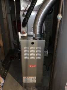 A new Bryant furnace installation with ductwork in a utility space by Proficient Heating & Cooling in Livonia, MI.