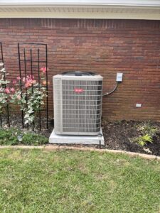 A newly installed Bryant outdoor AC unit next to a brick wall by Frye Air Services in Mobile, AL