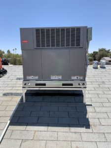 A new Bryant rooftop HVAC package unit installed on a stand by Arizaz Heating & Cooling in Chandler, AZ.