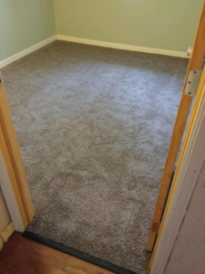 A newly installed light brown carpet in a bedroom by Carpet Direct of Northern Colorado in Loveland, CO.
