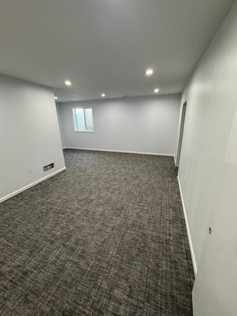 A newly installed gray patterned carpet in a room by Flooring World Wide LLC in Plainwell, MI.