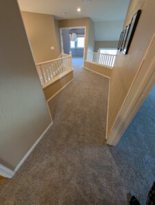A newly installed carpet in an upstairs hallway and landing area by Carpet Direct of Northern Colorado in Loveland, CO.
