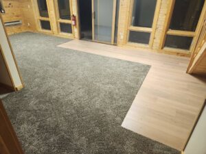 A large room with newly installed grey speckled carpet by N-B-R Floors in Fort Collins, CO