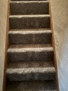 Professional new carpet installation on a residential staircase by Centennial Carpet & Flooring in Mitchell, SD.