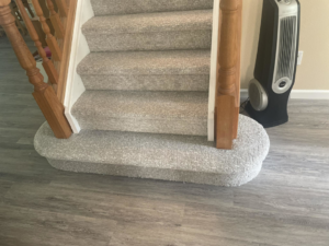Freshly installed light gray carpet on a staircase leading to a hard surface floor by Fairbanks Carpets Plus in Fairbanks, AK