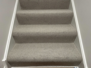 Newly installed patterned carpet on a staircase by Creative Carpet Solutions LLC in Houston, TX.