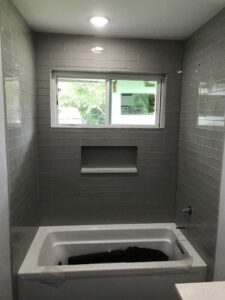 Newly installed beige carpet in a utility room, showcasing a completed carpet installation by Affordable Carpet & Flooring in Dallas, TX.