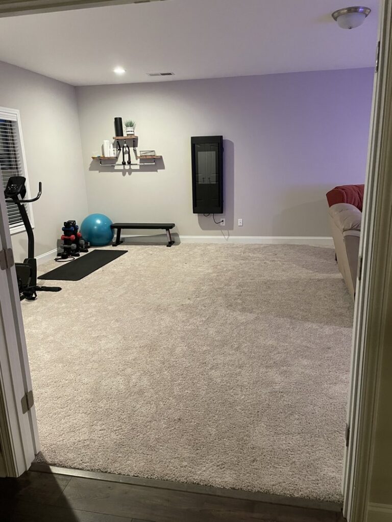 A room with newly installed light grey wall-to-wall carpet by Floorboys of Greenville in Greenville, SC.