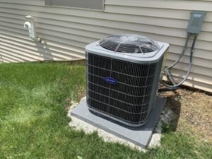 A newly installed Carrier outdoor air conditioner unit by Tom's Heating Service in Waukesha, WI.