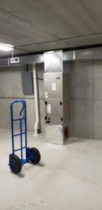 A new Carrier furnace and ductwork installation in a utility room by ICare Heating & Air in Millcreek, UT.