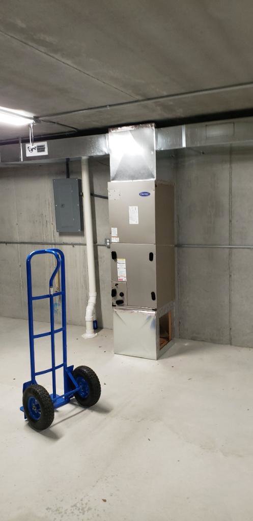 A new Carrier furnace and ductwork installation in a utility room by ICare Heating & Air in Millcreek, UT.