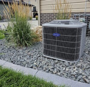 A newly installed Carrier outdoor AC unit at a residential property by EZ AIR HVAC in San Antonio, TX