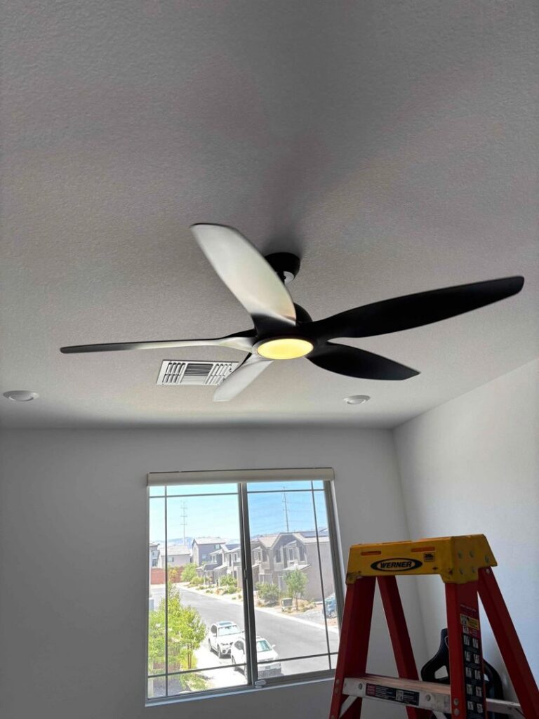A newly installed modern ceiling fan with a light in a home by Eco Electric in Las Vegas, NV.