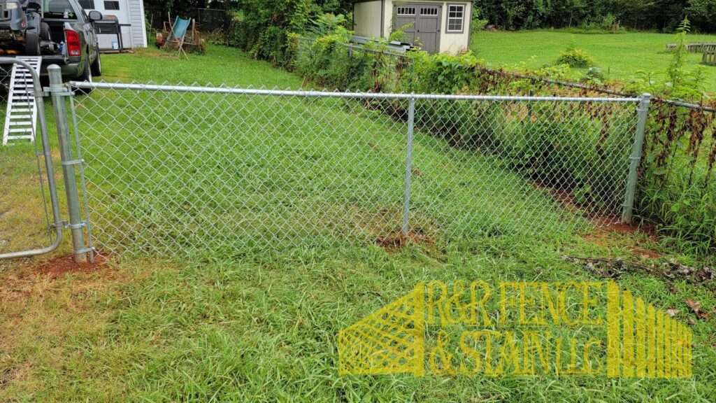 A newly installed chain-link fence by R&R Fence & Stain LLC in Madison, AL.