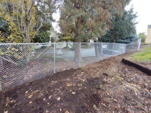 A newly installed chain-link fence by Stewart & Son Gate & Fence Co. in Hillsboro, OR