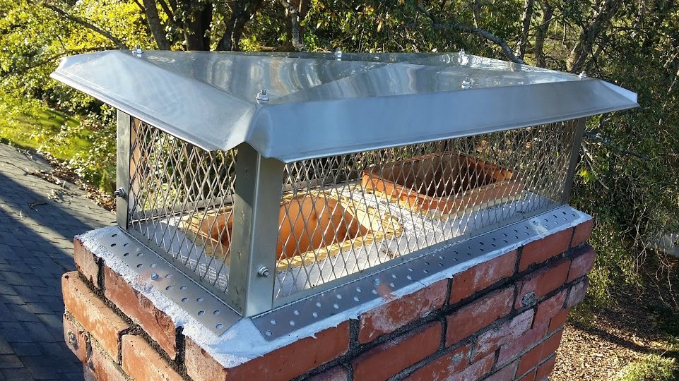A newly installed stainless steel chimney cap on a brick chimney by Chip's Chimney in Rapid City, SD