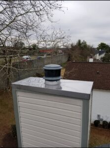 A close-up view of a newly installed chimney cap and liner by Eagles Nest Chimney Services and more of Cincinnati LLC in Cincinnati, OH.