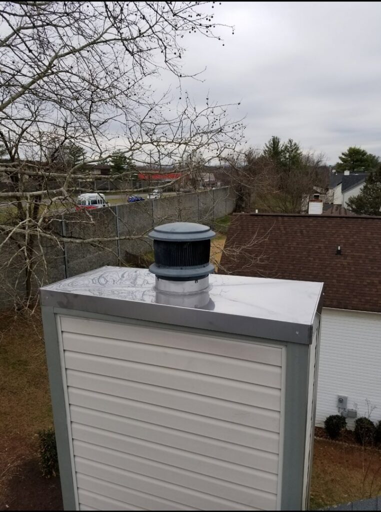 A close-up view of a newly installed chimney cap and liner by Eagles Nest Chimney Services and more of Cincinnati LLC in Cincinnati, OH.