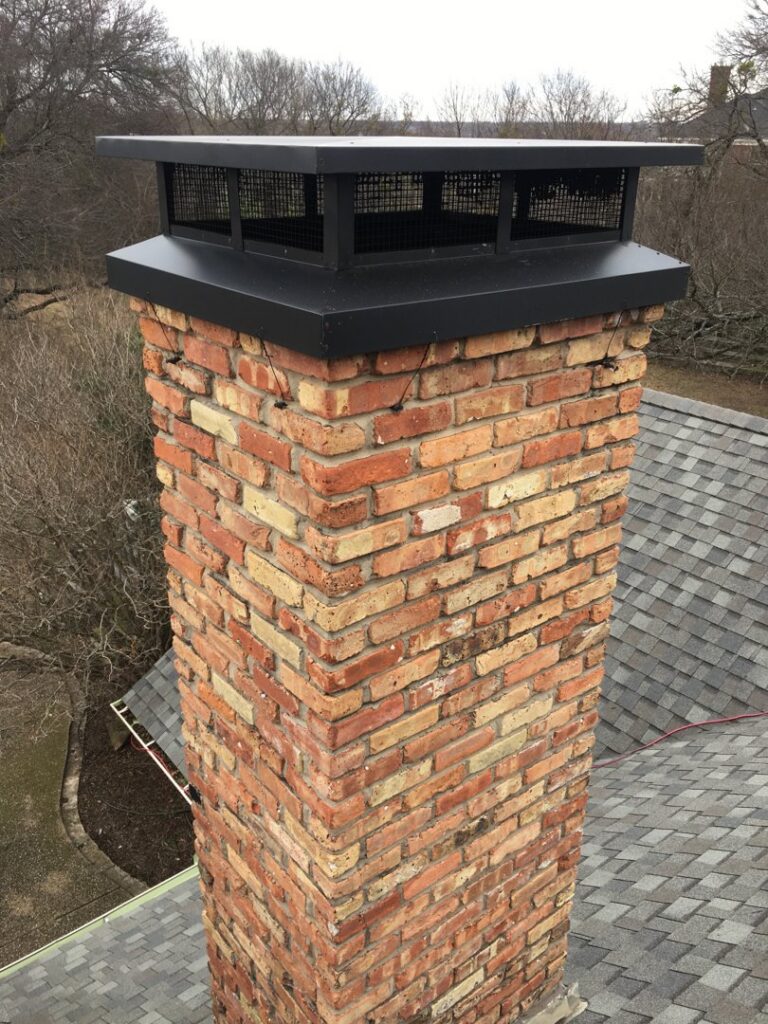 A newly installed black chimney cap on a brick chimney, showcasing a chimney service by HBR Hearth and Chimney in Dallas, TX