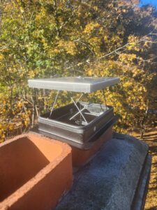 A newly installed chimney cap on a residential chimney, a service provided by Top Dog Hearth Repair & Maintenance, LLC in Worcester, MA