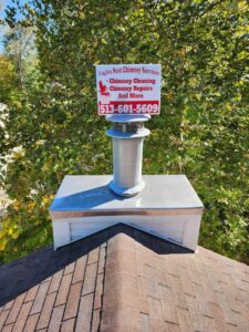 A newly installed chimney cap and liner system on a residential roof by Eagles Nest Chimney Services and more of Cincinnati LLC in Cincinnati, OH.