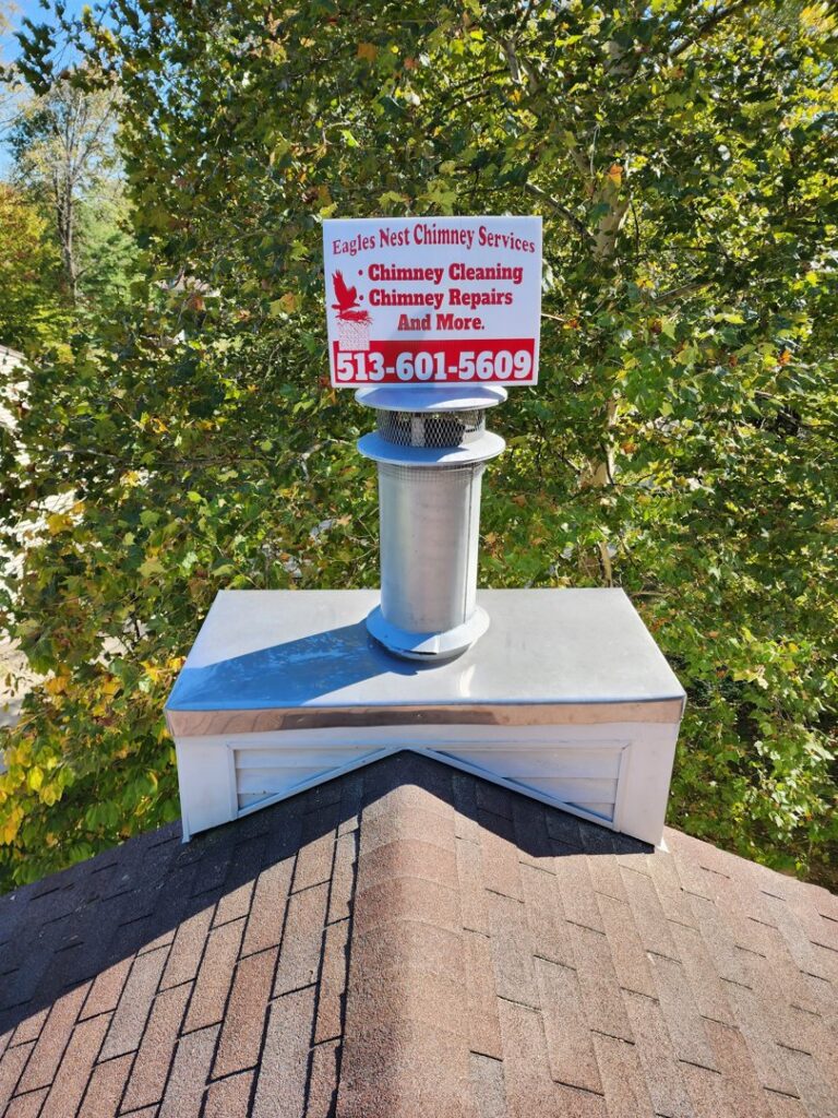 A newly installed chimney cap and liner system on a residential roof by Eagles Nest Chimney Services and more of Cincinnati LLC in Cincinnati, OH.