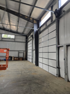 New commercial garage door installation inside a large building by Coles Garage Door Service, LLC in West Columbia, SC.