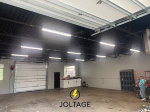 New commercial LED lighting installed in a warehouse or garage by Joltage LLC, providing bright illumination in Mobile, AL.