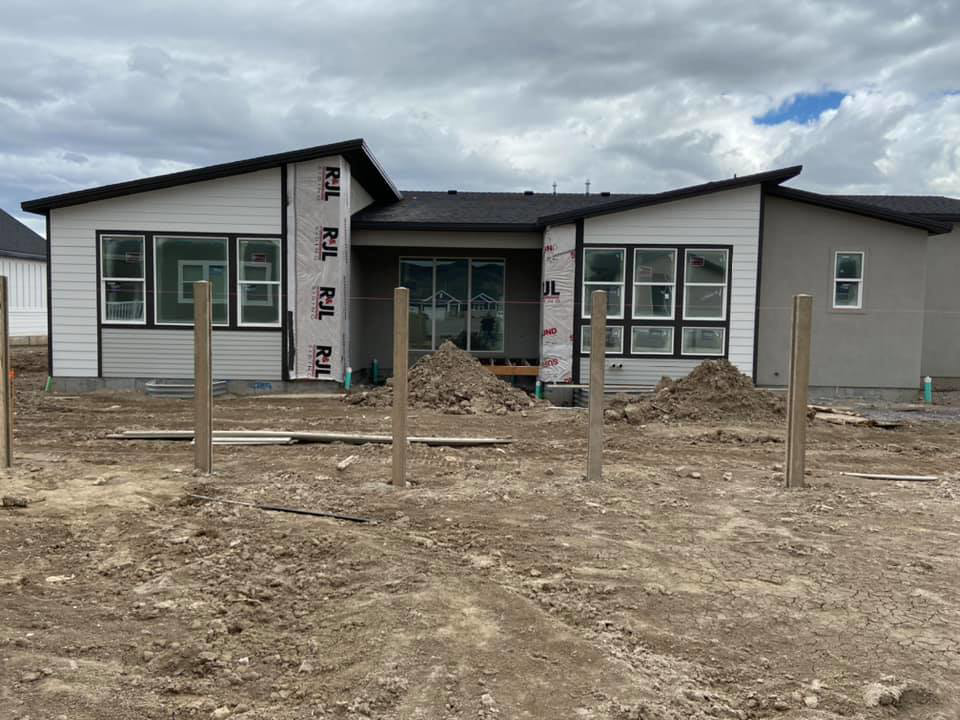 Newly installed concrete fence posts ready for panel attachment by BroKrete Fencing LLC in Salt Lake City, UT