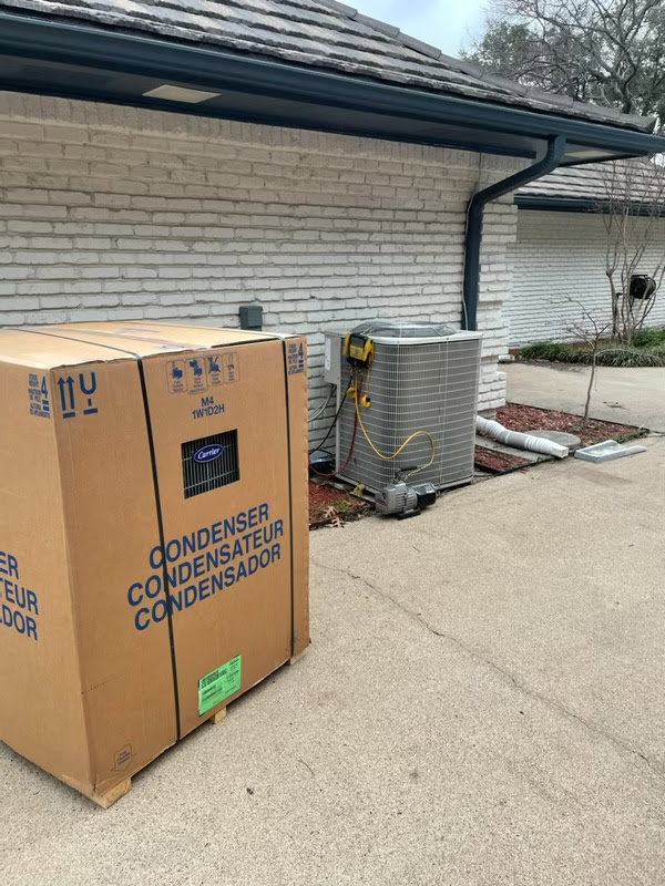 New condenser unit in box next to existing outdoor AC unit being serviced by Benavidez Heating & Air Conditioning In, Arlington, TX.