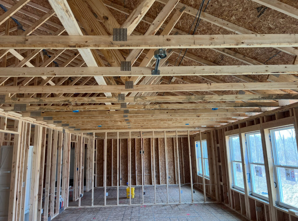 Interior of a house under construction with visible wooden framing and electrical rough-in work by Kouris Electric LLC in Canton, OH.