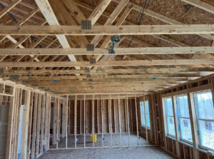 Interior of a house under construction with visible wooden framing and electrical rough-in work by Kouris Electric LLC in Canton, OH.