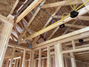 Electrical rough-in wiring and junction boxes installed in new construction framing by Trademark Elite Electrical Services in Butte, MT