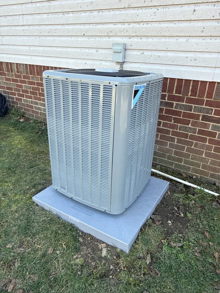 A newly installed Daikin outdoor HVAC unit next to a residential building by Southern Comfort Heating & Air, LLC in Chattanooga, TN.