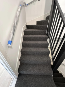 New dark grey carpet installed on stairs by J&A Flooring Masters Corp. in Joliet, IL.