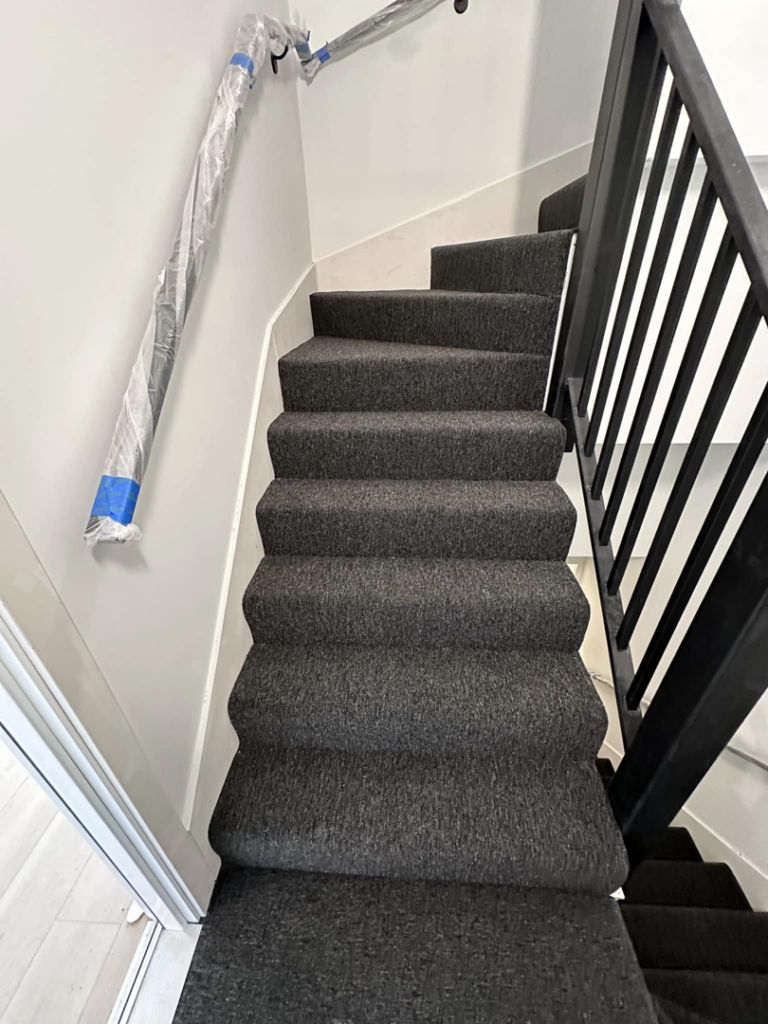 New dark grey carpet installed on stairs by J&A Flooring Masters Corp. in Joliet, IL.
