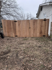 A new darker wood privacy fence with a double gate, expertly installed by Mayan Fence & Outdoor LLC in Phoenix, AZ.