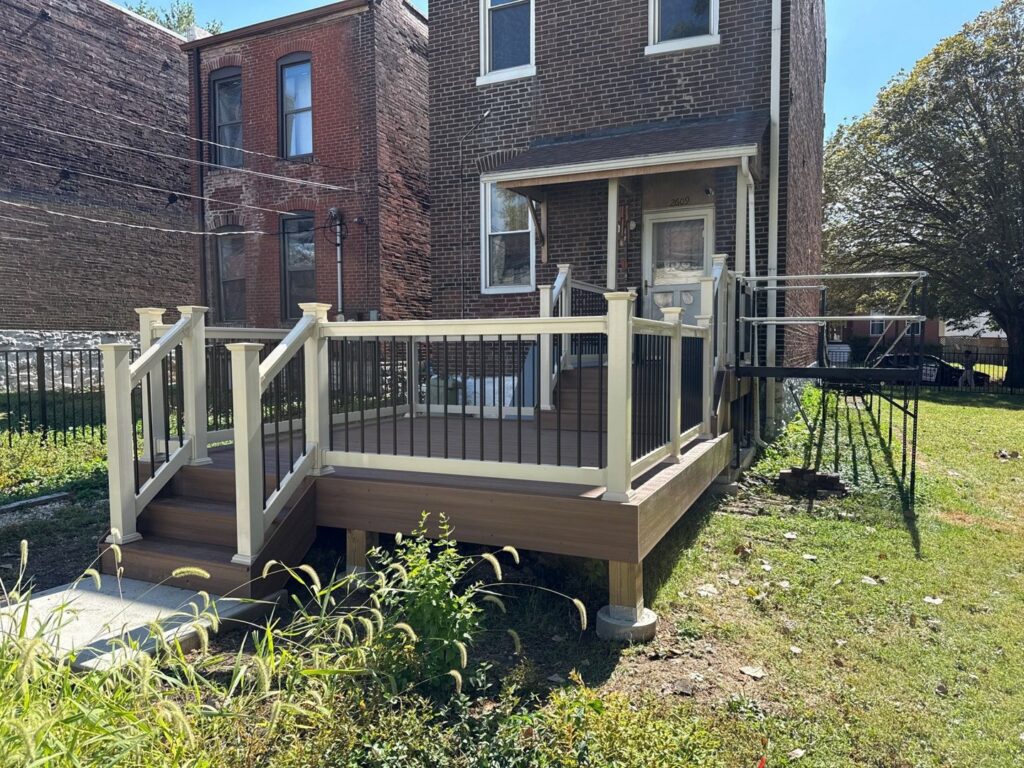 A newly built deck featuring white and black railings with stairs, completed by Chesley Fence & Deck in Fairview Heights, IL.