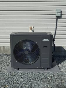 A new Delta outdoor HVAC unit installed on a gravel bed next to a residential building in Wilson, NC.