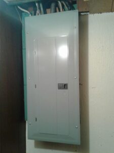A new electrical breaker panel installed on a wall by In the Light Electrical LLC in Kansas City, KS