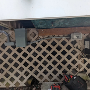 Installation of new electrical conduit, junction boxes, and an outdoor outlet under a deck by Alt Electric LLC in Federal Way, WA.