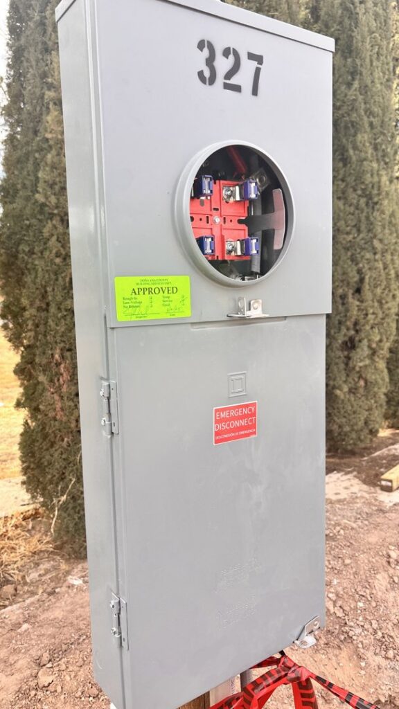 A newly installed electrical meter base with an approved sticker by EMT Electric in Las Cruces, NM