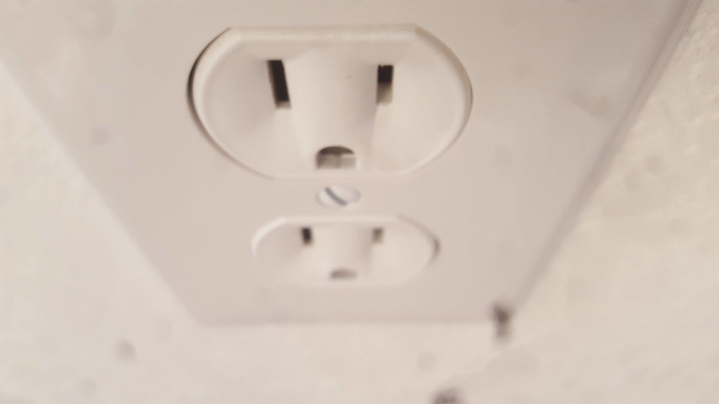 A newly installed white electrical outlet by Your Electrician in Yakima, WA.