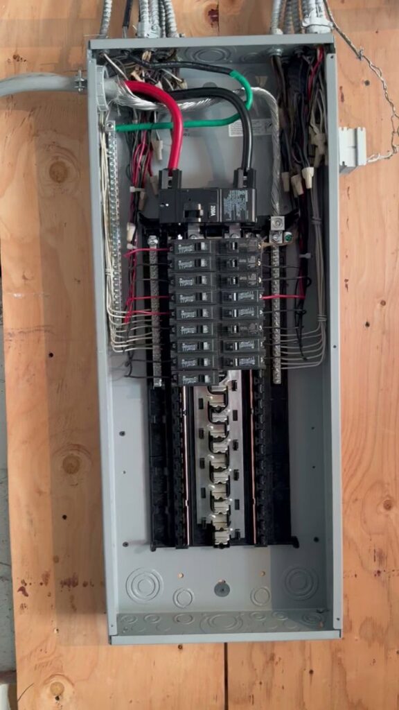A newly installed electrical panel with circuit breakers and main wiring by York Electric of Westchester in Yonkers, NY.