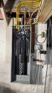 A newly installed electrical panel with organized wiring by Joshua Melendez Electrician LLC in New Bedford, MA.